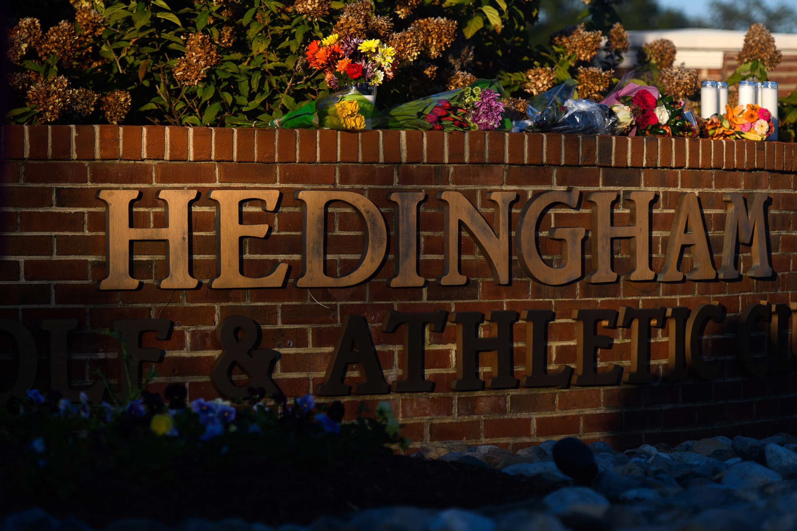 PHOTO: Flowers lay at the entrance of the Hedingham neighborhood, Oct. 14, 2022, in Raleigh, N.C., after a shooting left five dead.