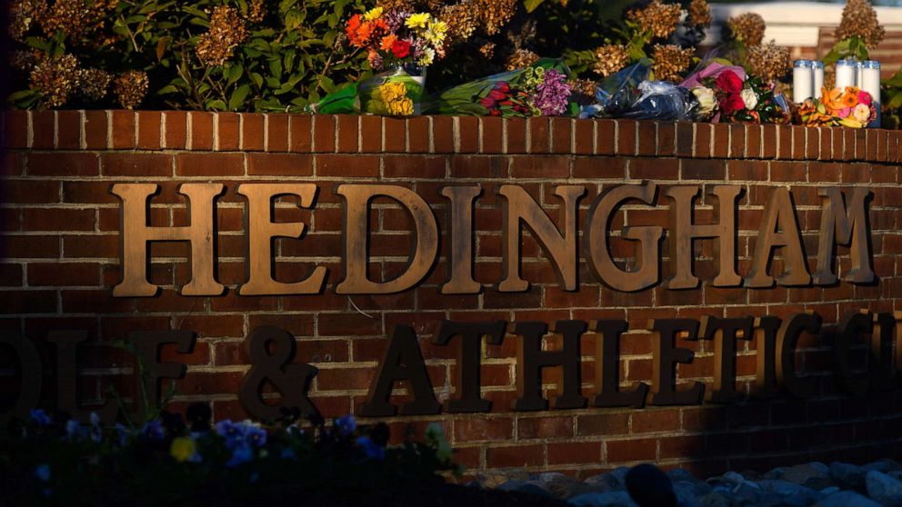 PHOTO: Flowers lay at the entrance of the Hedingham neighborhood, Oct. 14, 2022, in Raleigh, N.C., after a shooting left five dead.