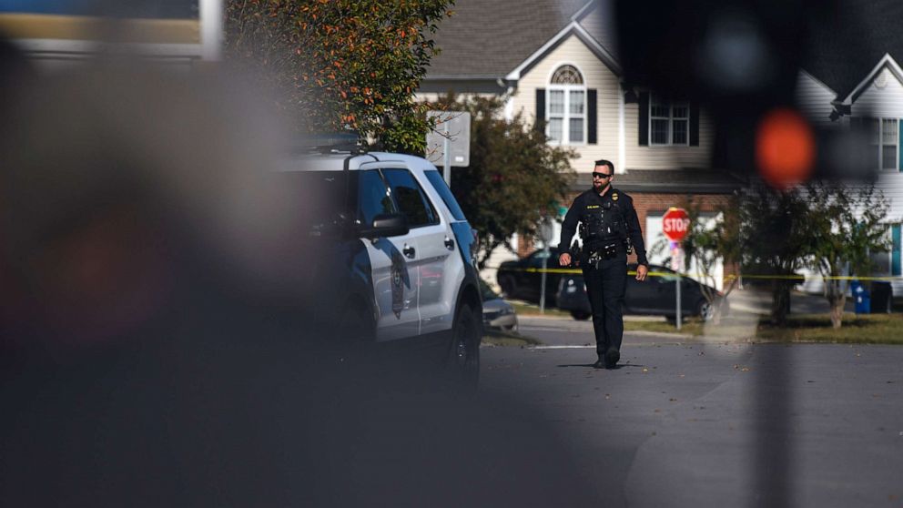 PHOTO: A police officer walks along Castle Pines Drive in the Hedingham neighborhood of Raleigh, N.C., Oct. 14, 2022, where 5 people were shot and killed.
