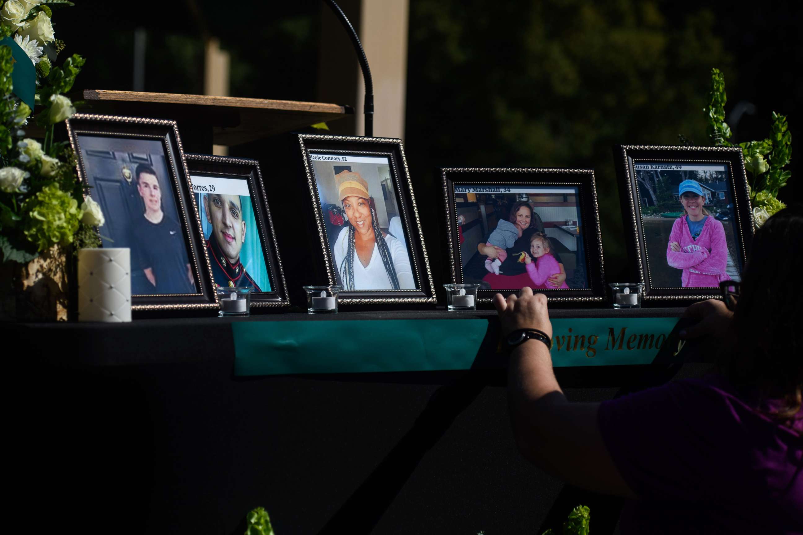 PHOTO: People set up a memorial table with images of the shooting victims for a vigil in the Hedingham neighborhood, Oct. 15, 2022, in Raleigh, N.C.