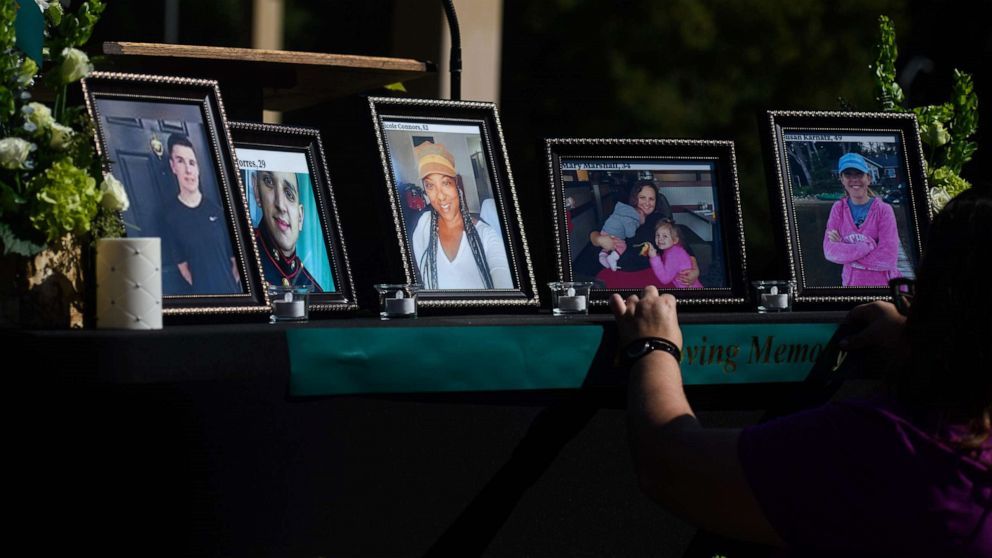 PHOTO: People set up a memorial table with images of the shooting victims for a vigil in the Hedingham neighborhood, Oct. 15, 2022, in Raleigh, N.C.