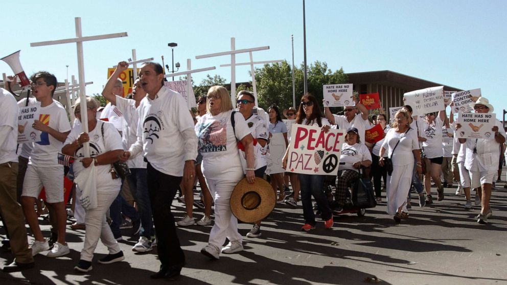 PHOTO: Participants in the League of United Latin American Citizens' "March For a United America," carry signs in El Paso, Texas, on Saturday, Aug. 10, 2019.
