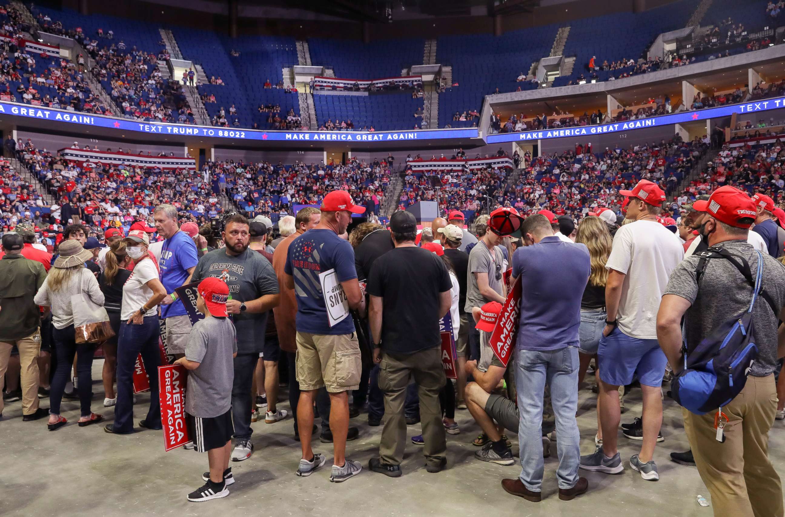 PHOTO: Supporters of U.S. President Donald Trump wait for him to appear onstage 27 minutes before the scheduled start of his speech, at his first re-election campaign rally in several months in the midst of the coronavirus disease (COVID-19) outbreak.