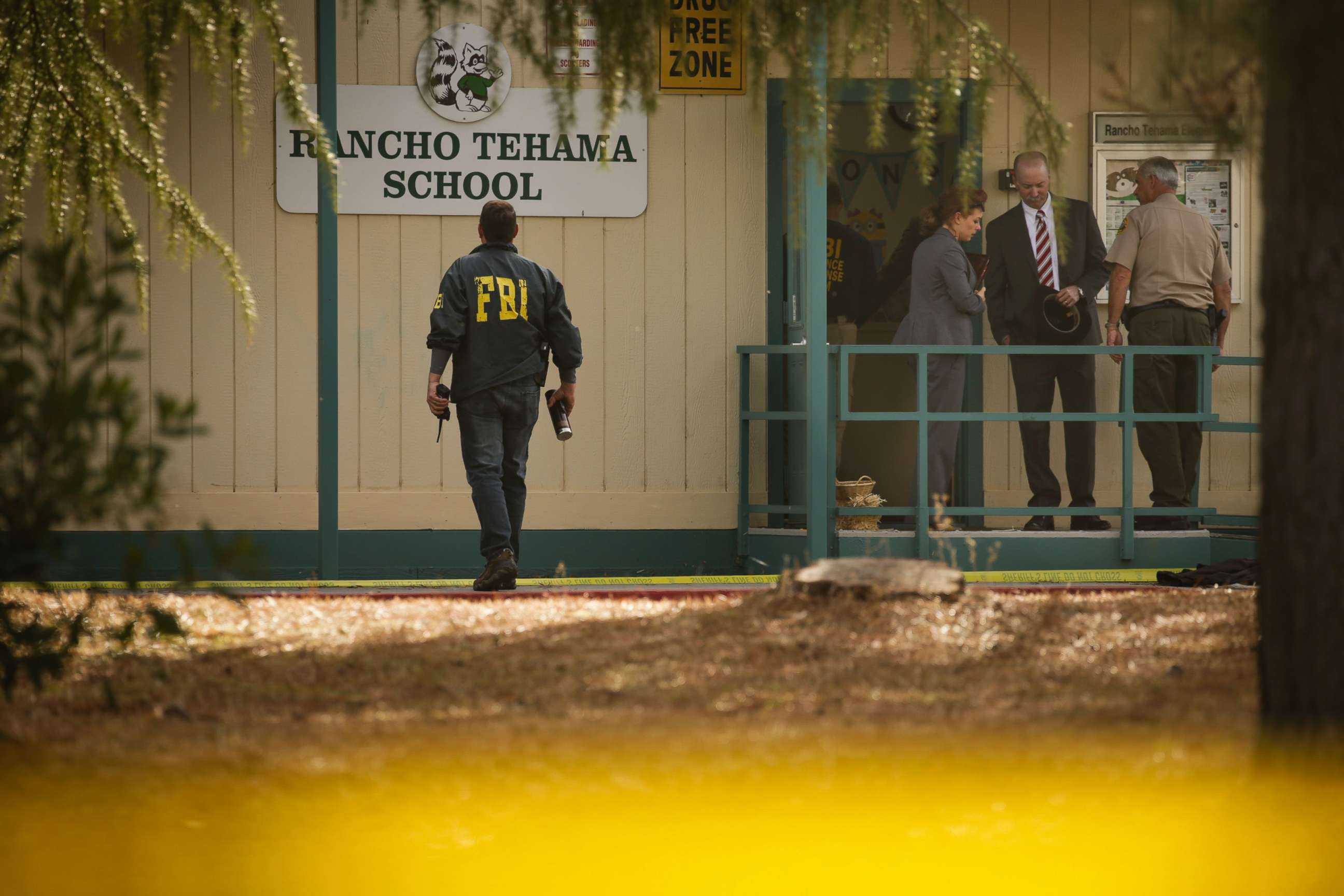 PHOTO: FBI agents are seen behind yellow crime scene tape outside Rancho Tehama Elementary School after a shooting in the morning on Nov. 14, 2017, in Rancho Tehama, Calif.