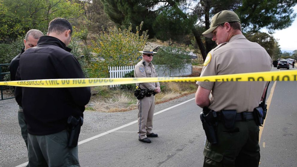 PHOTO: Law enforcement officers stand near one of many crime scenes after a shooting on Nov. 14, 2017, in Rancho Tehama, Calif.