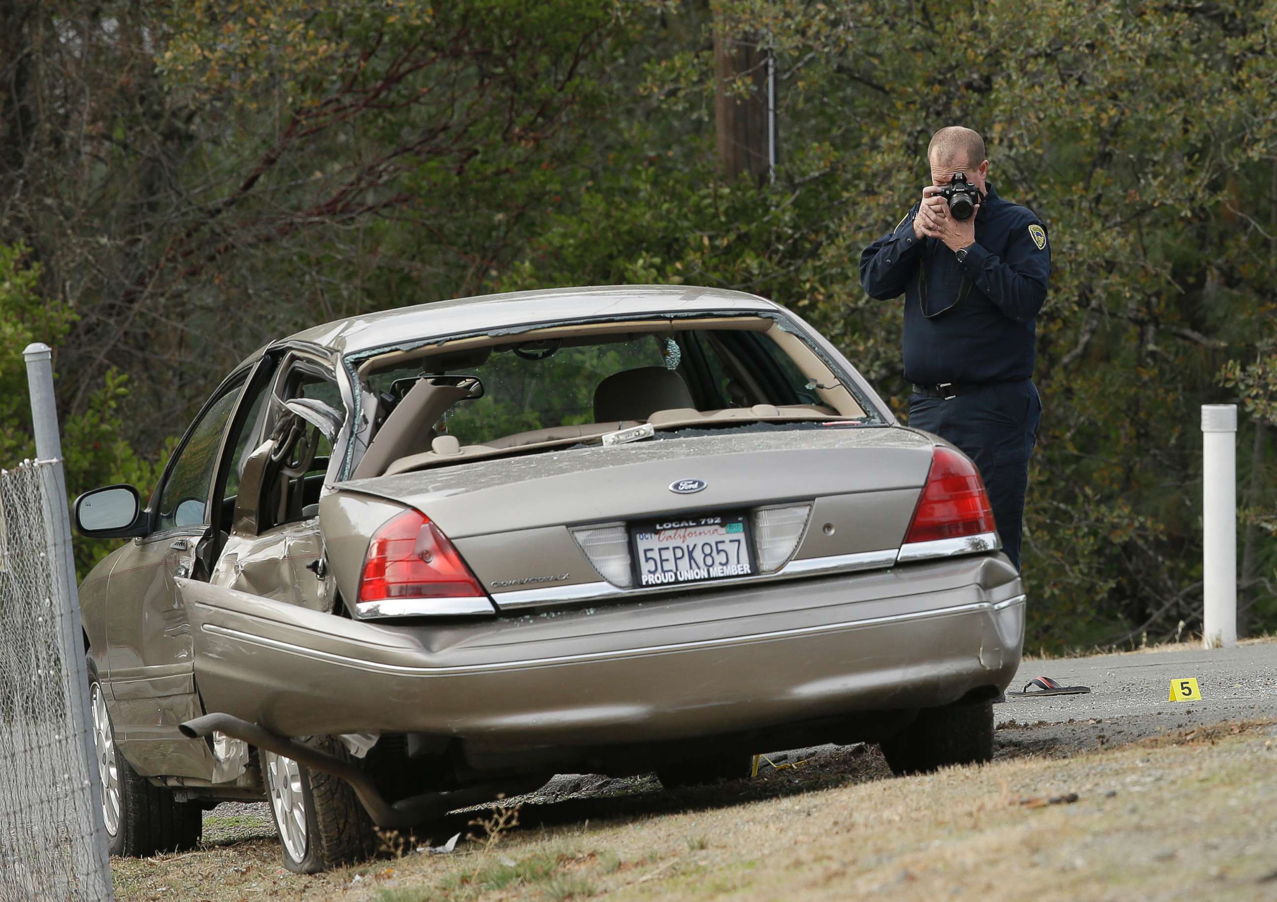 PHOTO: A California Highway patrol officer photographs a vehicle involved in a deadly shooting rampage at the Rancho Tehama Reserve, near Corning, Calif., Nov. 14, 2017.