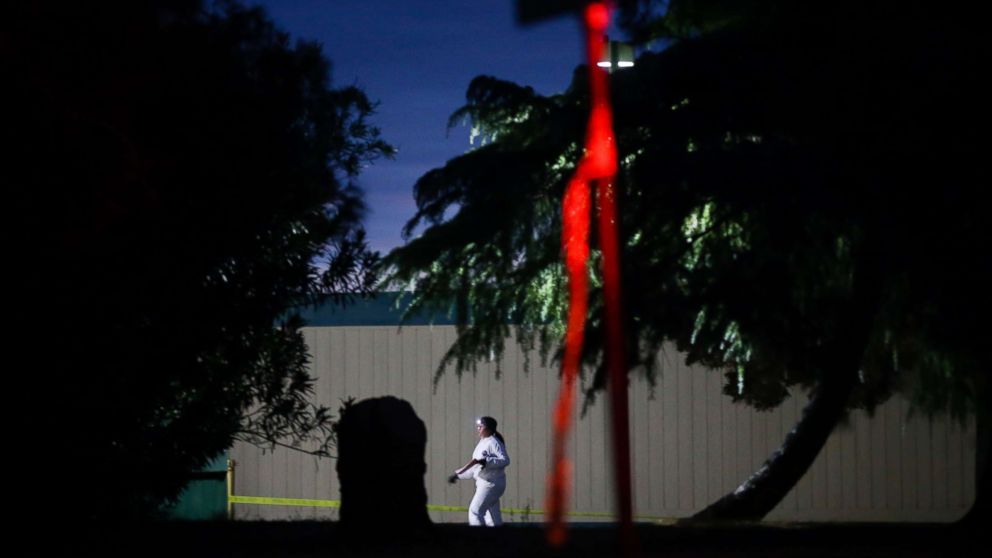 PHOTO: A woman wearing a white protective suit is seen on the Rancho Tehama Elementary school grounds after a shooting on Nov. 14, 2017, in Rancho Tehama, Calif.