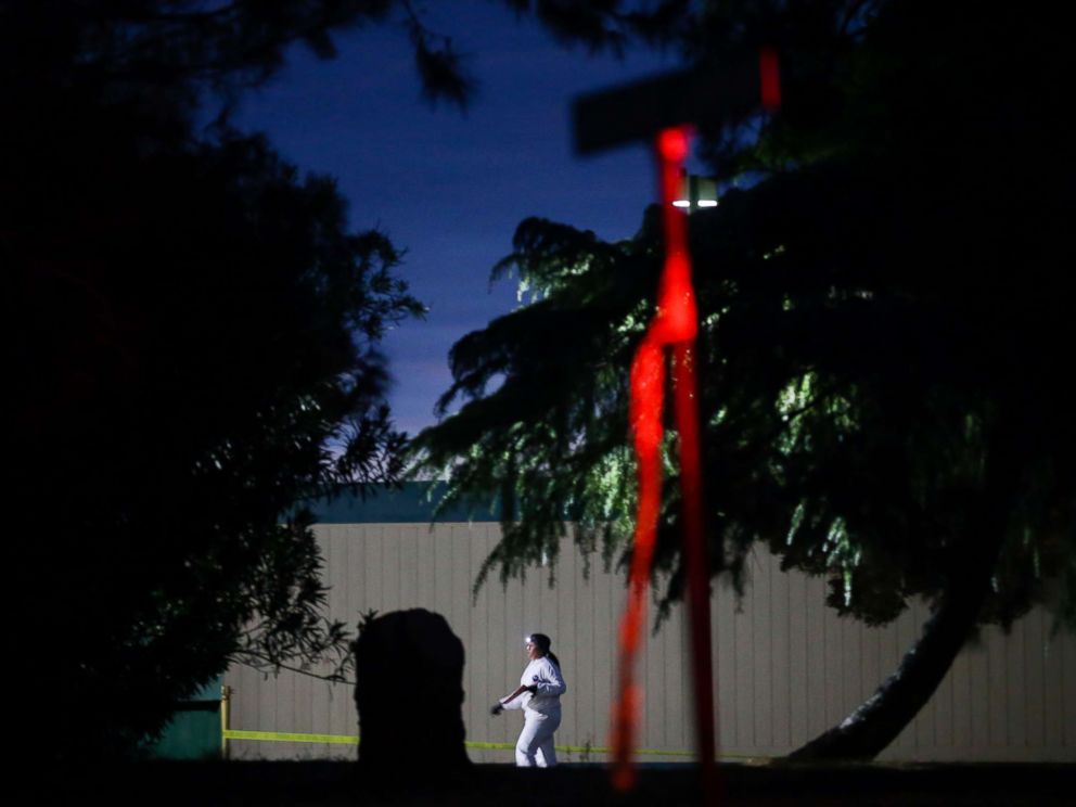 PHOTO: A woman wearing a white protective suit is seen on the Rancho Tehama Elementary school grounds after a shooting on Nov. 14, 2017, in Rancho Tehama, Calif.