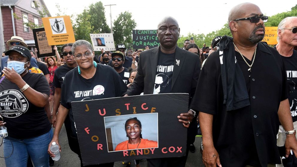 PHOTO: In this July 8, 2022, file photo, Doreen Coleman, mother of Richard "Randy" Cox Jr., walks with civil rights attorney Benjamin Crump during a march for Justice for Randy Cox on Dixwell Avenue in New Haven, Conn.