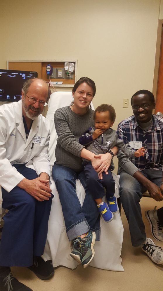 PHOTO: Parents Nicole and Caleb Choge and big brother Corban Choge are pictured with the family's doctor Dr. Emanuel Vlastos before their rare set of identical triplets were born. 