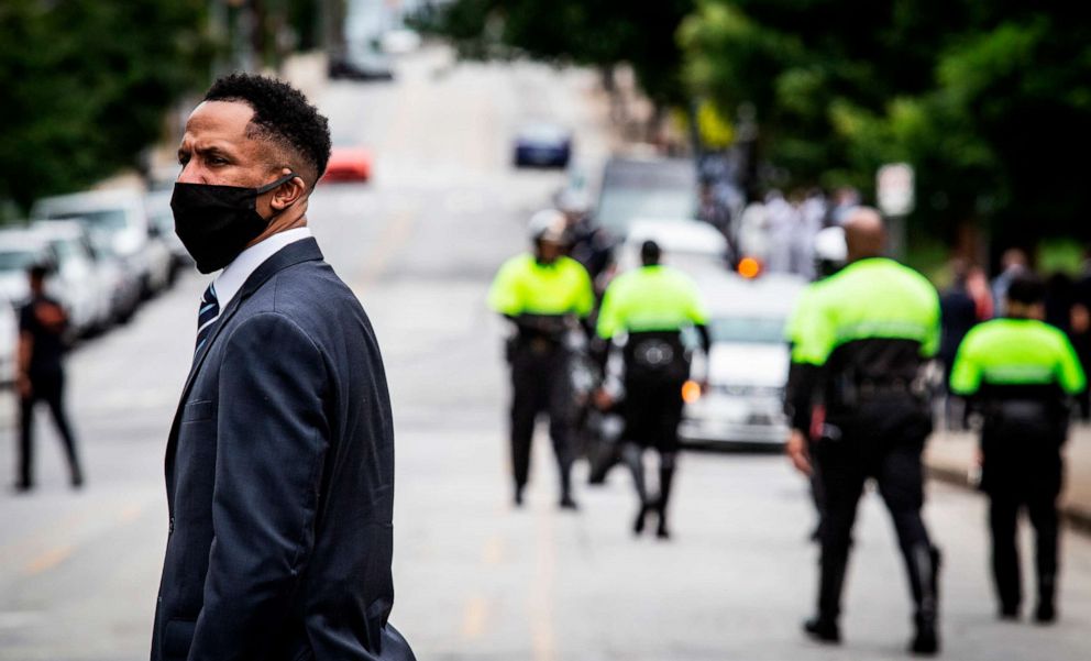 PHOTO: A man stands in the street as the family of Rayshard Brooks arrives for Brooks' funeral at Ebeneezer Baptist Church, June 23, 2020, in Atlanta.