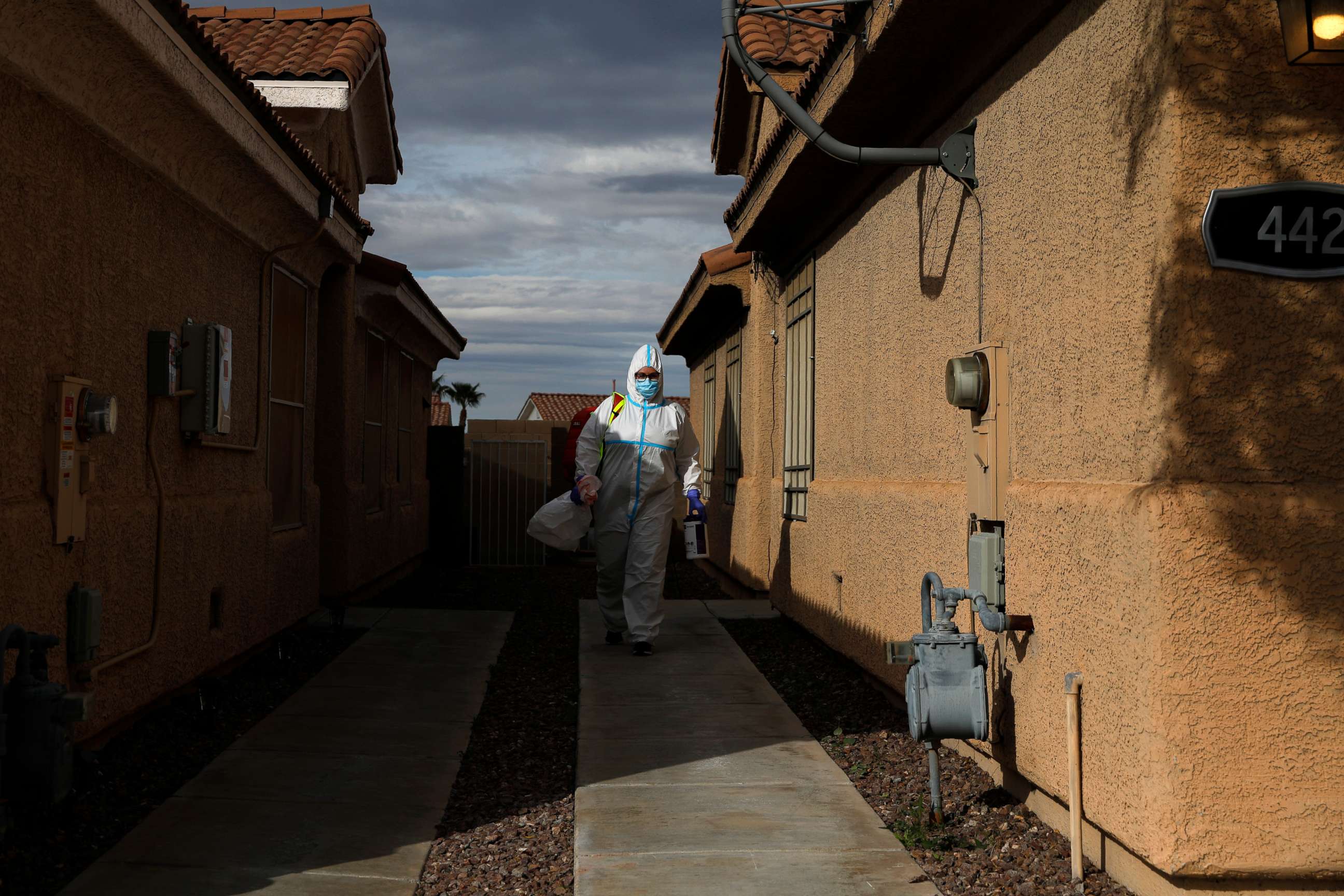 PHOTO: Paramedic Chelsea Monge, of Ready Responders, leaves a home while wearing personal protective gear after making a house call for a possible coronavirus patient, April 10, 2020, in Henderson, Nev.