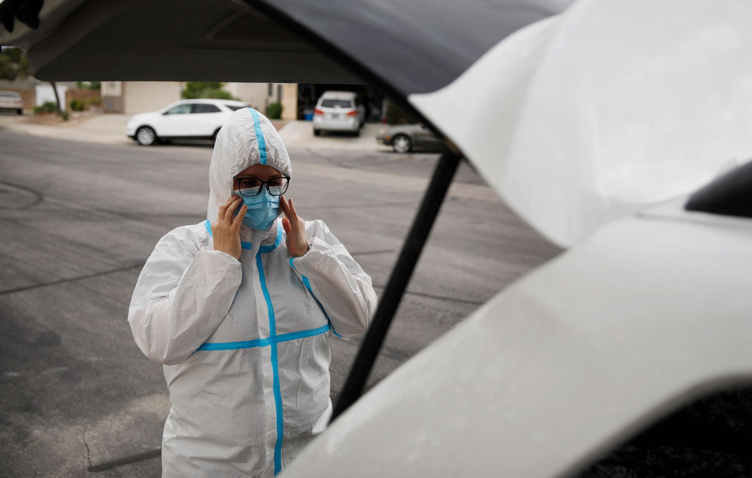 PHOTO: Paramedic Chelsea Monge, of Ready Responders, dons personal protective gear before making a house call for a possible coronavirus patient Friday, April 10, 2020, in Henderson, Nev.