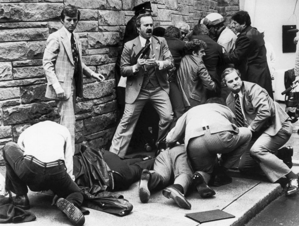 PHOTO: Secret Service agents, police officers, and bystanders take action seconds after shots were fired at President Reagan and his retinue by John Hinckley, Jr.