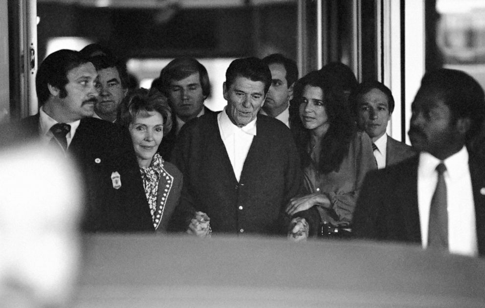 PICTURED: President Ronald Reagan, assisted by First Lady Nancy Reagan and their youngest daughter, Patti Davis, leaves George Washington University Hospital in Washington after being shot by John Hinckley, Jr., April 11, 1981.