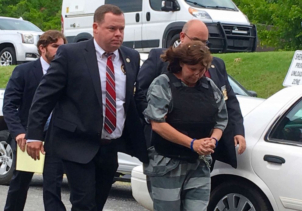 PHOTO:In this Monday, June 17, 2019, photo, Randolph County Sheriff Kevin Bell, left, leads Rebecca Lynn O'Donnell to a hearing in Randolph County Circuit Court in Pocahontas, Ark.