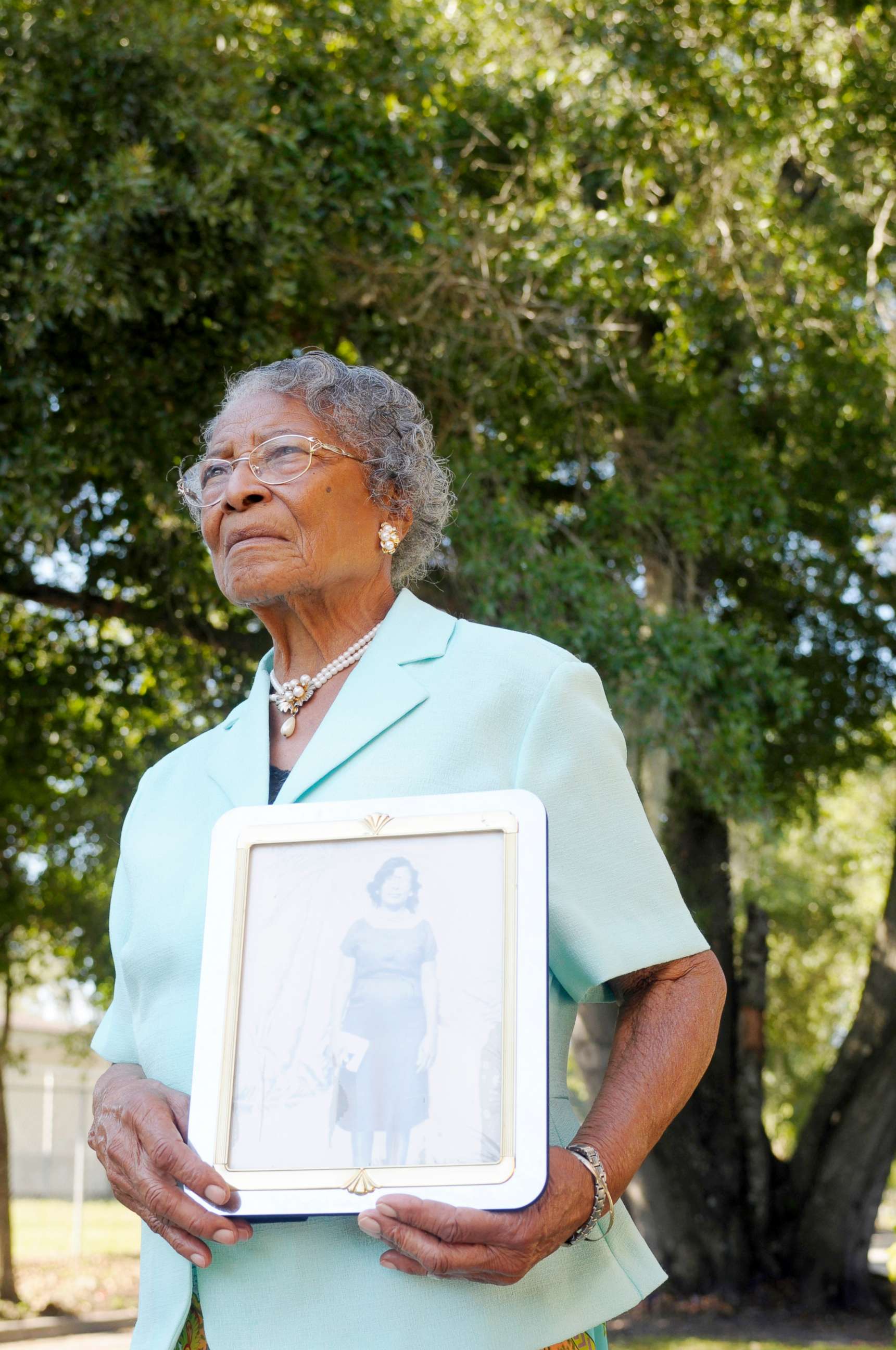 PHOTO: Recy Taylor, 90, holds a photo of herself from her days in Abbeville, Ala., outside her home in Winter Haven, Fla., Oct. 7, 2010.