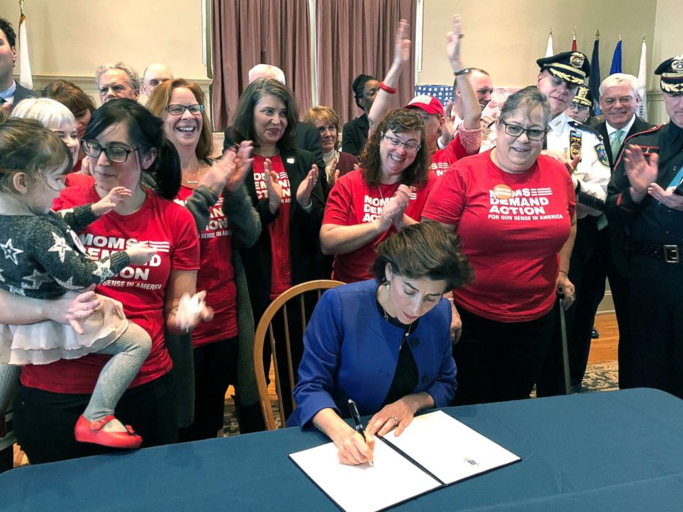 PHOTO: Cheers erupt as Rhode Island Gov. Gina Raimondo signs an executive order, Feb. 26, 2018, in Warwick, R.I., to establish a new policy to try to keep guns away from people who show warning signs of violence.