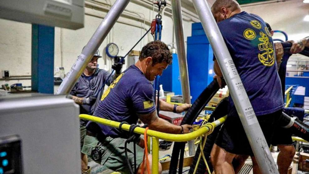 PHOTO: U.S. Navy Mobile Diving Salvage Unit One performs inspection and sampling of a water well, as Navy divers try to remove fuel from a water shaft at Red Hill near Hawaii's Pearl Harbor, Dec. 11, 2021.  