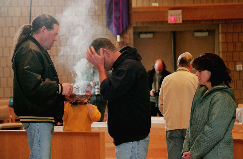 PHOTO: Robert Cook from the Red Lake Indian Reservation, performs a traditional ceremony at St. Phillip Church during a memorial service to mourn the victims killed at Red Lake High School, March 23, 2005, in Bemidji, Minn.