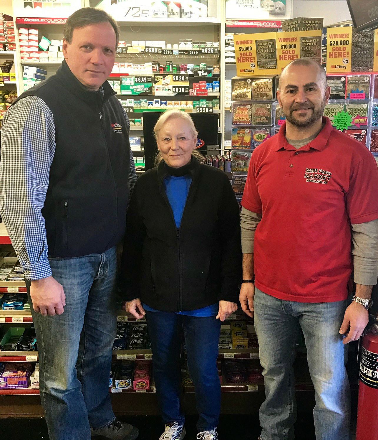 PHOTO: Pictured (L-R) are Charlie McIntyre, executive director of the New Hampshire Lottery, Kathy Robinson, clerk, Reed's Ferry Market and Sam Safa, owner, Reed's Ferry Market.