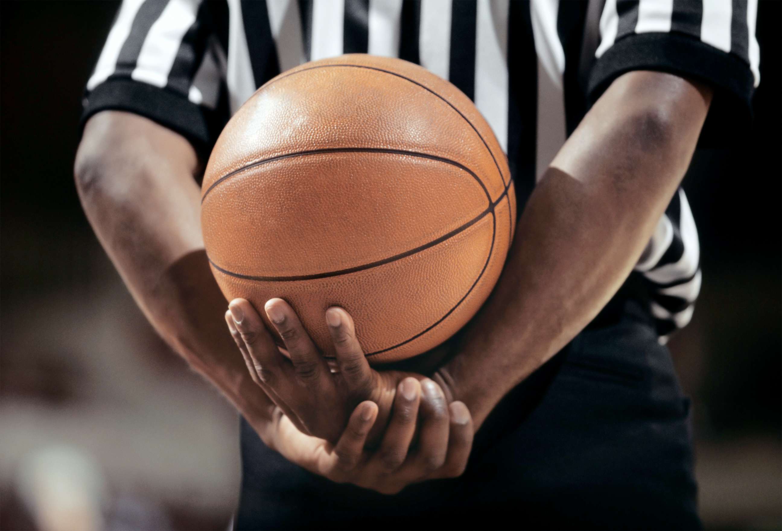 PHOTO: A referee holds a basketball.