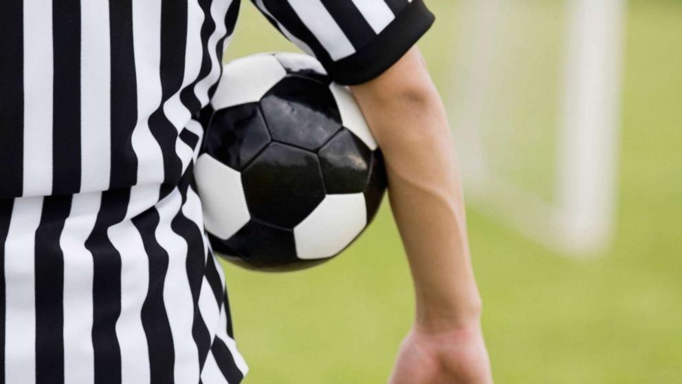 A referee is pictured with a soccer ball under his arm in this undated stock photo.