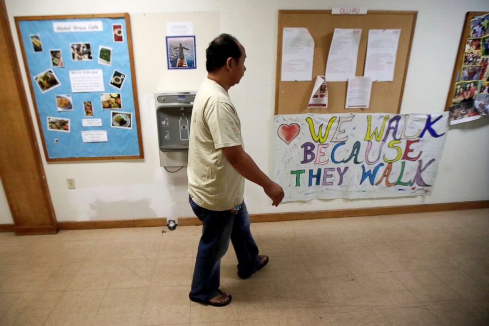 PHOTO: Arthur Jemmy walks through a hallway at The Reformed Church of Highland Park, where he and his wife are taking sanctuary to avoid deportation in Highland Park, N.J.