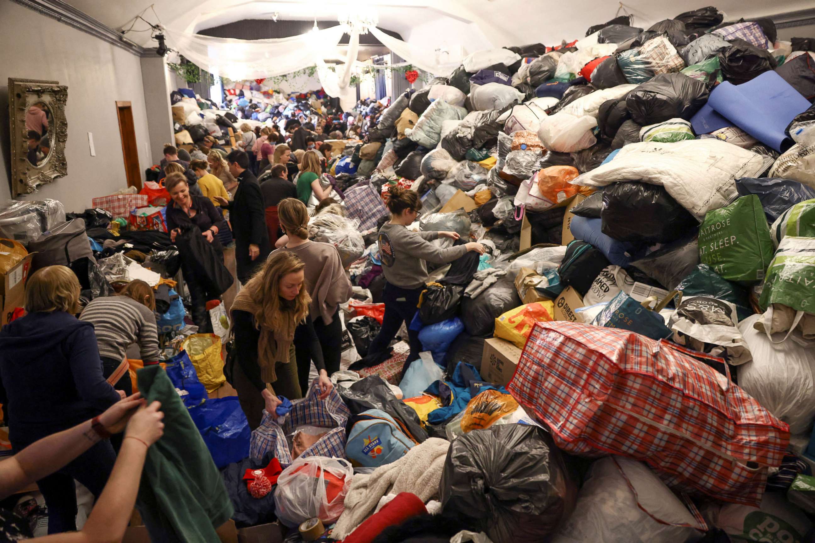 PHOTO: Volunteers sort through donations at the White Eagle Club, ahead of their convoy leaving to deliver aid to those fleeing the Russian invasion in Ukraine, in London, Feb. 28, 2022.