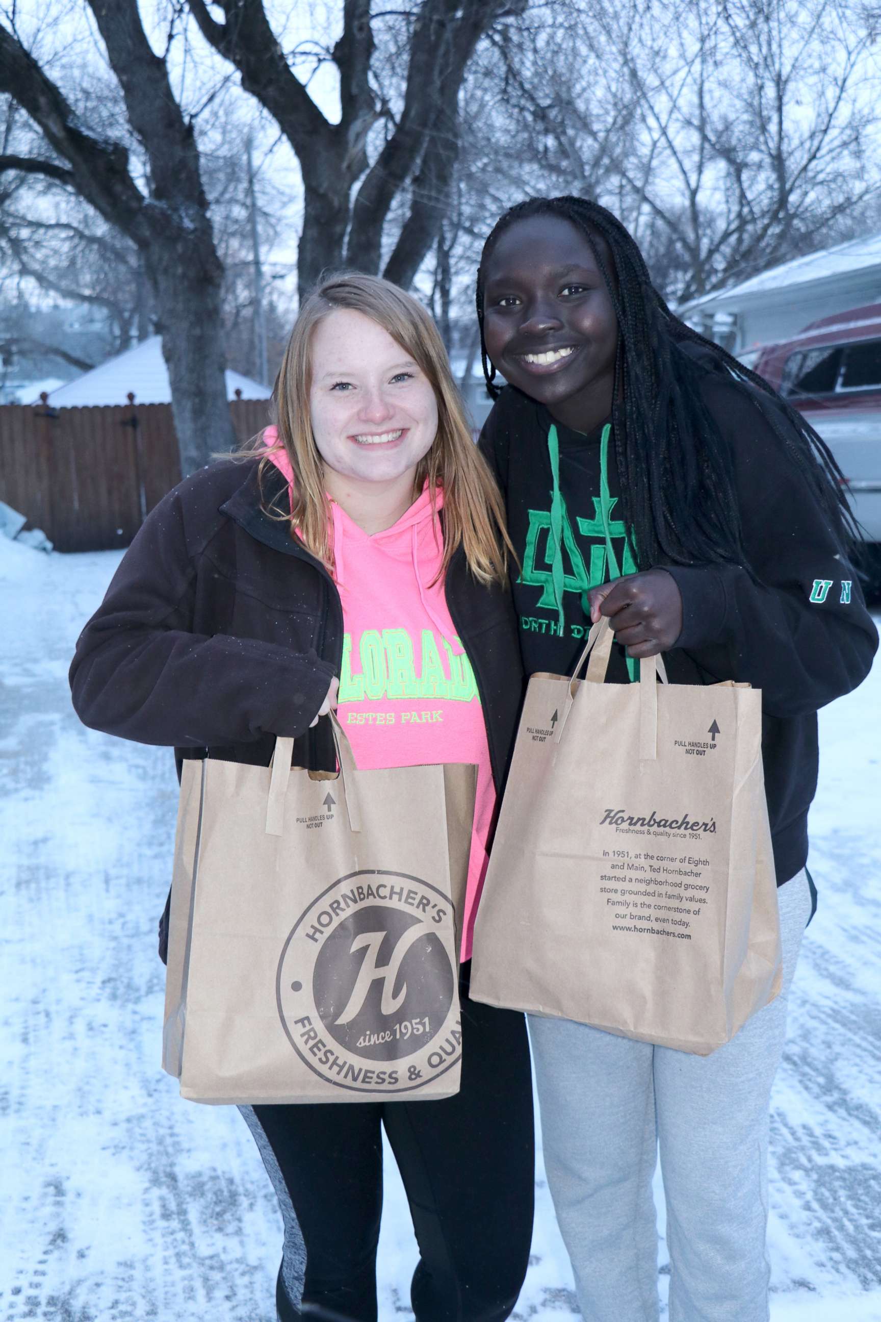 PHOTO: Students from Legacy Children's Foundation completing community service by making deliveries to hungry families that need help getting food on the table in undated photo.