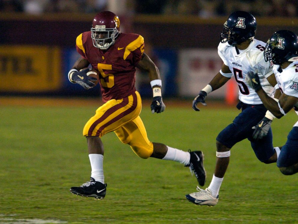 PHOTO: In this Nov. 13, 2004, file photo, USC running back Reggie Bush is pursued by Antoine Cason and Wilrey Fontenot of Arizona during 49-9 victory in Pacific-10 Conference football game at the Los Angeles Memorial Coliseum in Los Angeles.