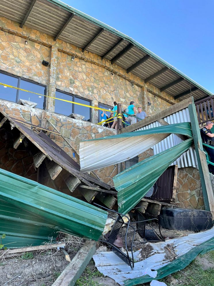 PHOTO: Investigators with Hamilton County, TN Office of Emergency Management & Homeland Security survey the collapse of a deck at Zoi's Restaurant in Harbor Lights Marina in Soddy-Daisy, Tenn., May 1, 2021.
