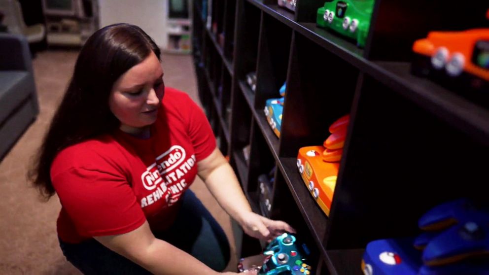 PHOTO: Retro game collector Brandi Ahmer shows off her various N64 consoles that she's acquired.