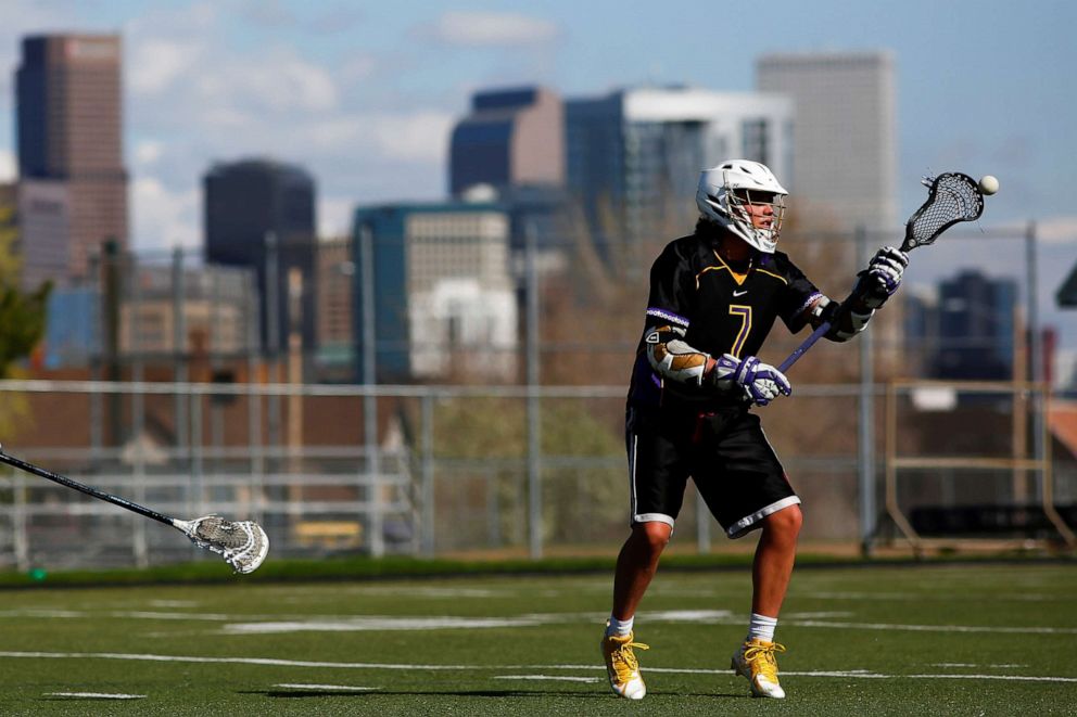 PHOTO: Shane Wolf, 18, practices lacrosse at North High School in Denver, April 28, 2021.
