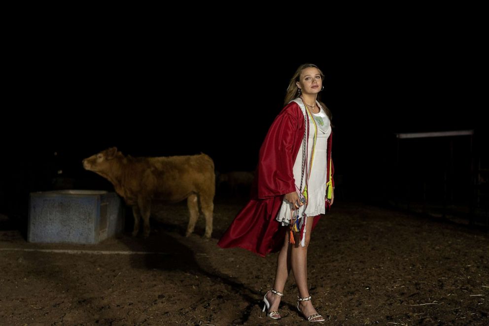 PHOTO: Kate Munson, 18, poses for a photo on the ranch which her family owns, after her graduation ceremony at Shallowater High School in Shallowater, Texas, May 21, 2021.