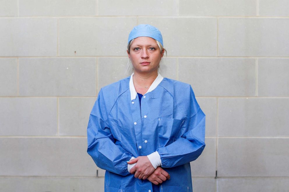 PHOTO: Jacqueline Hamil, 30, a registered nurse who is caring for COVID-19 patients in an emergency department, poses for a photograph after a 12-hour shift outside the hospital where she works, during the coronavirus disease outbreak, Md., April 6, 2020.