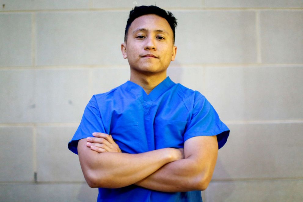 PHOTO: Ernest Capadngan, 29, a registered nurse who works at a biocontainment unit with COVID-19 patients, poses for a photograph after a 12-hour shift, outside the hospital where he works, during the coronavirus disease outbreak, Md., April 3, 2020.