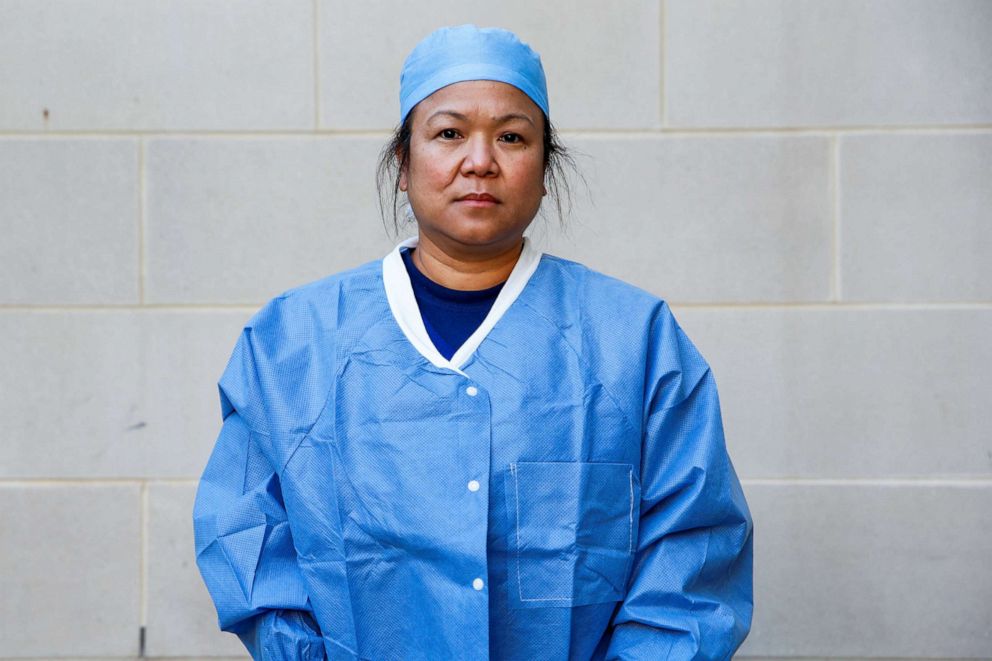 PHOTO: Cheryll Mack, 46, a registered nurse who is caring for COVID-19 patients in the emergency department, poses for a photograph after a 12-hour shift outside the hospital where she works, during the coronavirus disease outbreak, Md., April 10, 2020. 