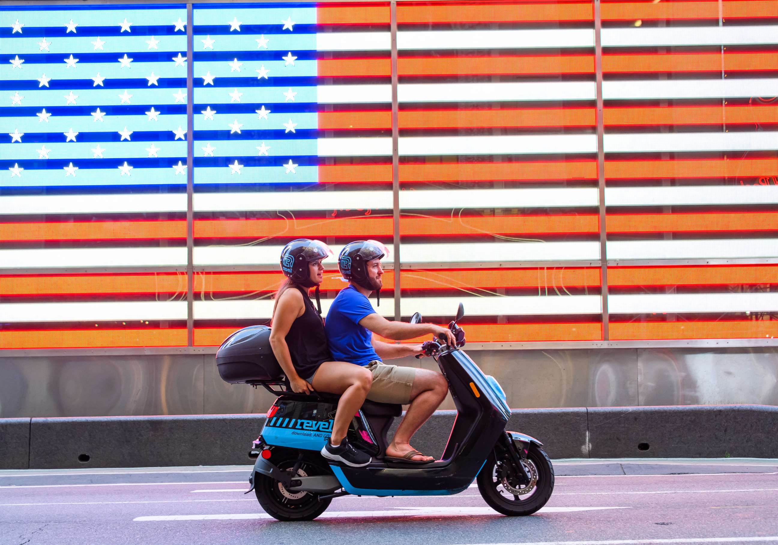 PHOTO: People ride a Revel scooter in Times Square on July 14, 2020 in New York City.