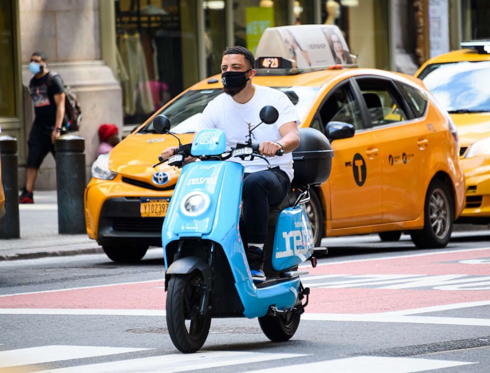PHOTO: A person rides a Revel scooter in midtown as New York City moves into Phase 3 of re-opening following restrictions imposed to curb the coronavirus pandemic on July 14, 2020 in New York City.