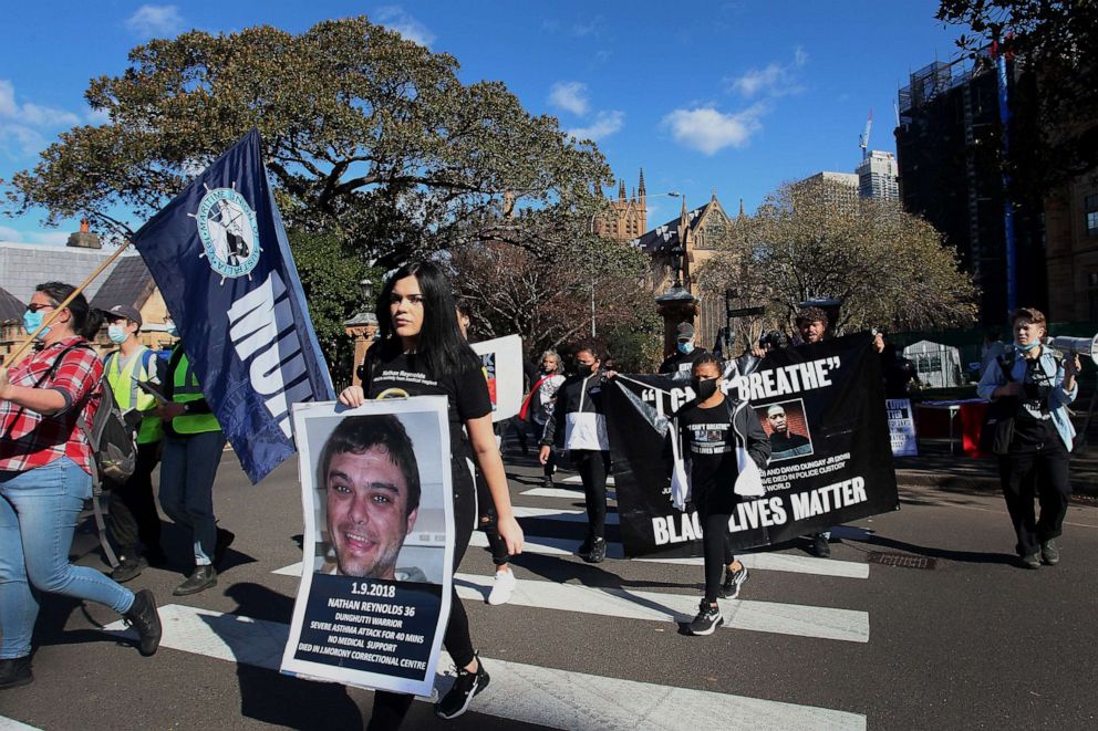 PHOTO: Activists walk towards The Domain to rally against Aboriginal and Torres Strait Islander deaths in custody, July 5, 2020, in Sydney, Australia. 