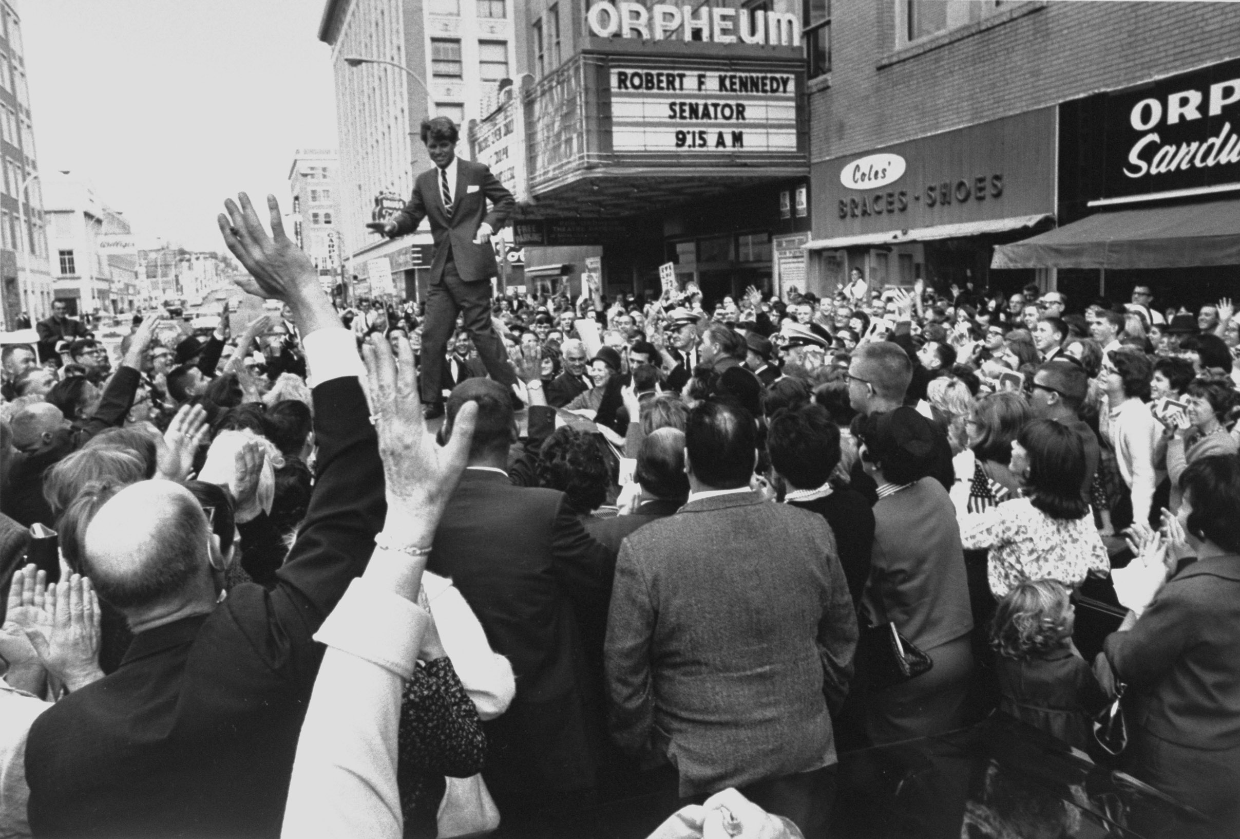 PHOTO: Sen. Robert Kennedy standing on roof of car as he is swamped by a crowd of welcoming well-wishers while campaigning for a local democratic congressional candidate, in Sioux City, 1966.