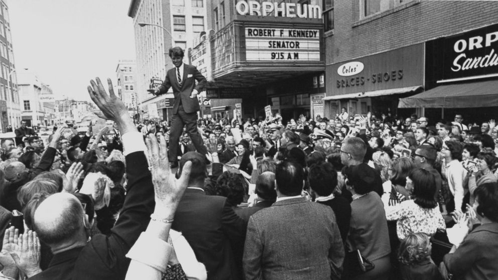 PHOTO: Sen. Robert Kennedy standing on roof of car as he is swamped by a crowd of welcoming well-wishers while campaigning for a local democratic congressional candidate, in Sioux City, 1966.