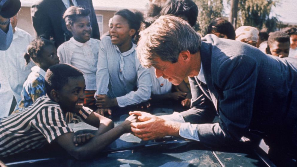 PHOTO: Presidential contender Bobby Kennedy stops during campaigning to shake hands with delighted young boy, April 1968.