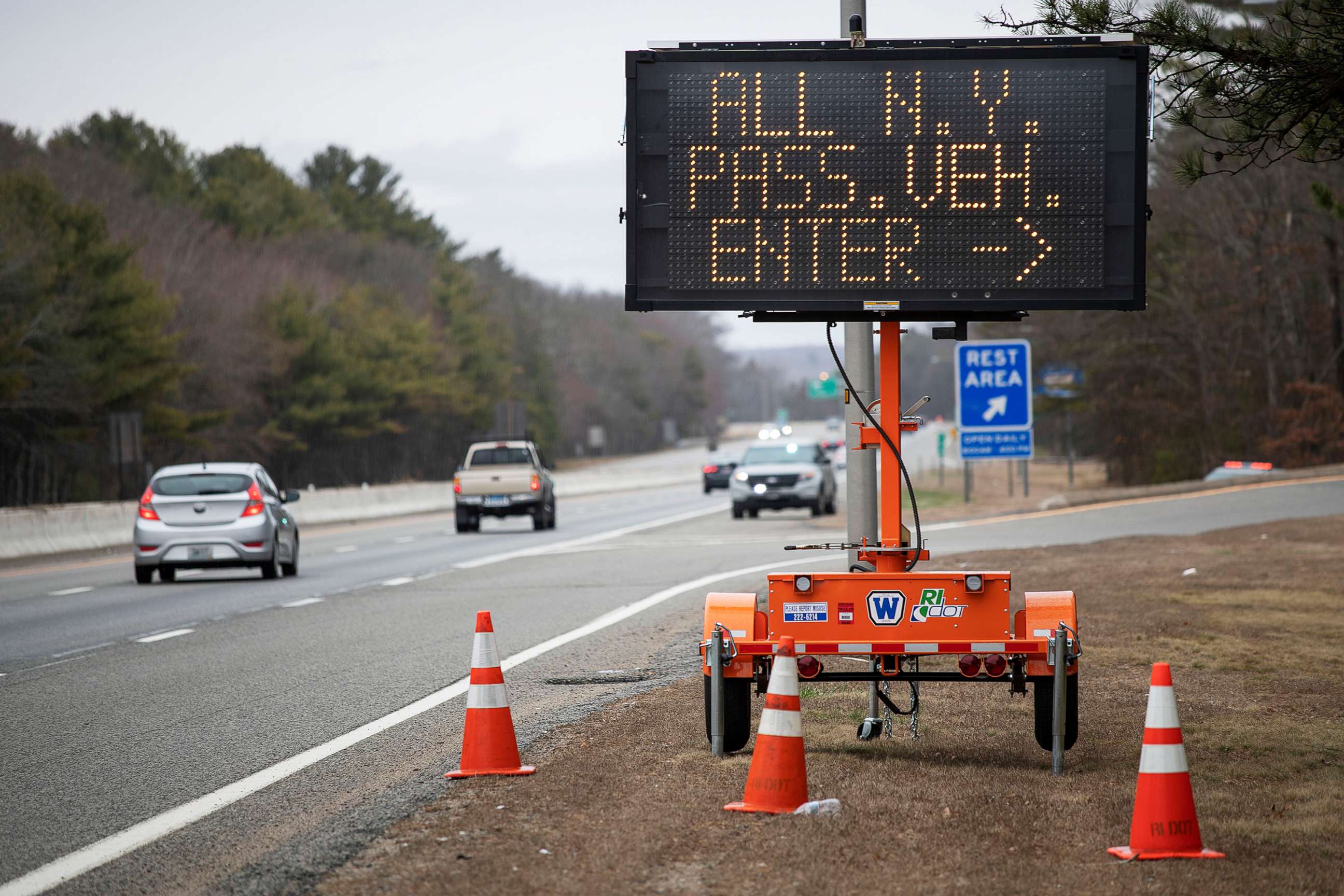 PHOTO: A sign instructs motorists with New York license plates to pull over at a checkpoint on I-95 where New Yorkers must pull over and provide contact information and are told to self-quarantine for two weeks, March 28, 2020, in Hope Valley, R.I. 