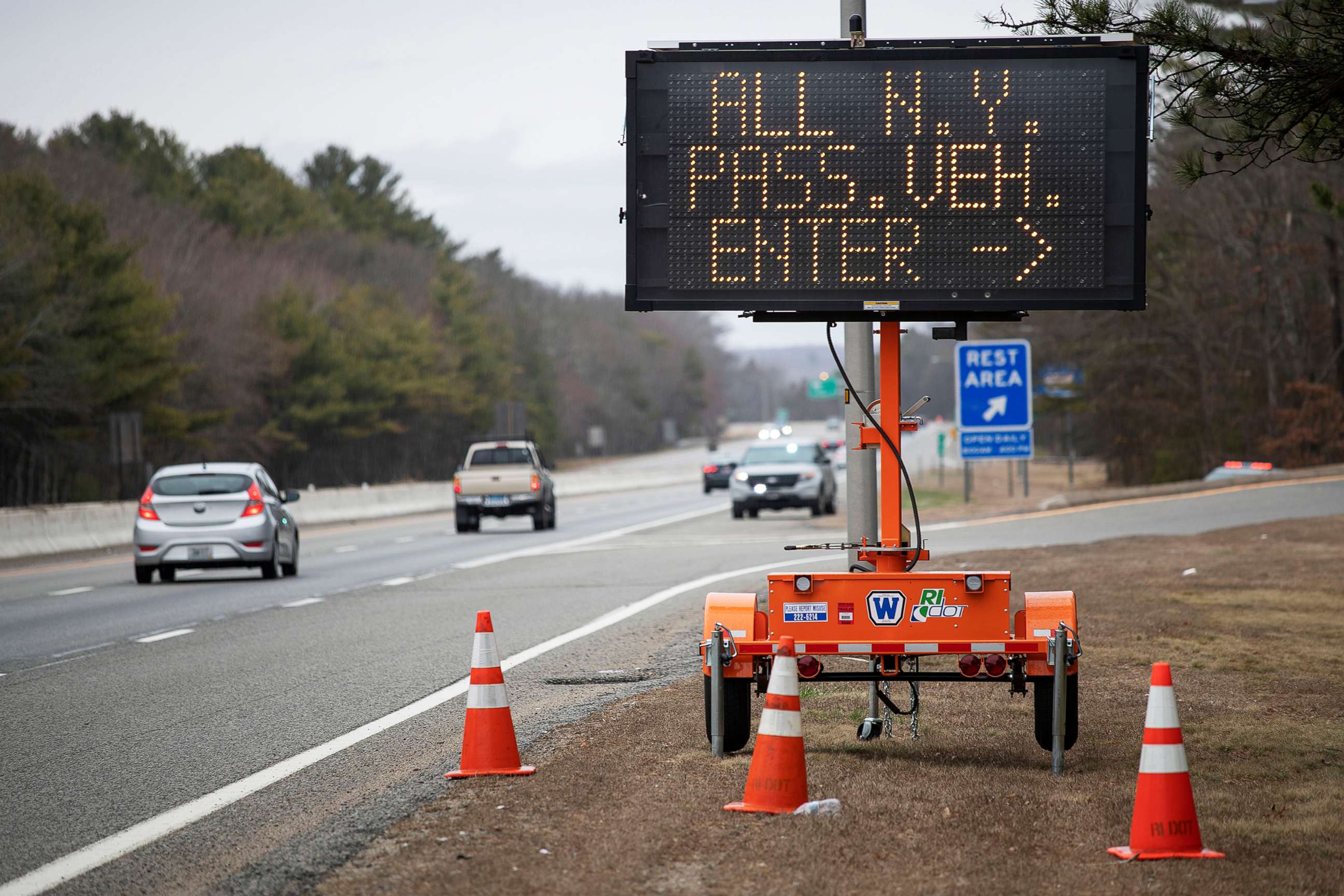 PHOTO: A sign instructs motorists with New York license plates to pull over at a checkpoint on I-95 where New Yorkers must pull over and provide contact information and are told to self-quarantine for two weeks, March 28, 2020, in Hope Valley, R.I.