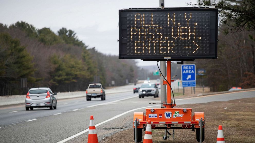 PHOTO: A sign instructs motorists with New York license plates to pull over at a checkpoint on I-95 where New Yorkers must pull over and provide contact information and are told to self-quarantine for two weeks, March 28, 2020, in Hope Valley, R.I. 