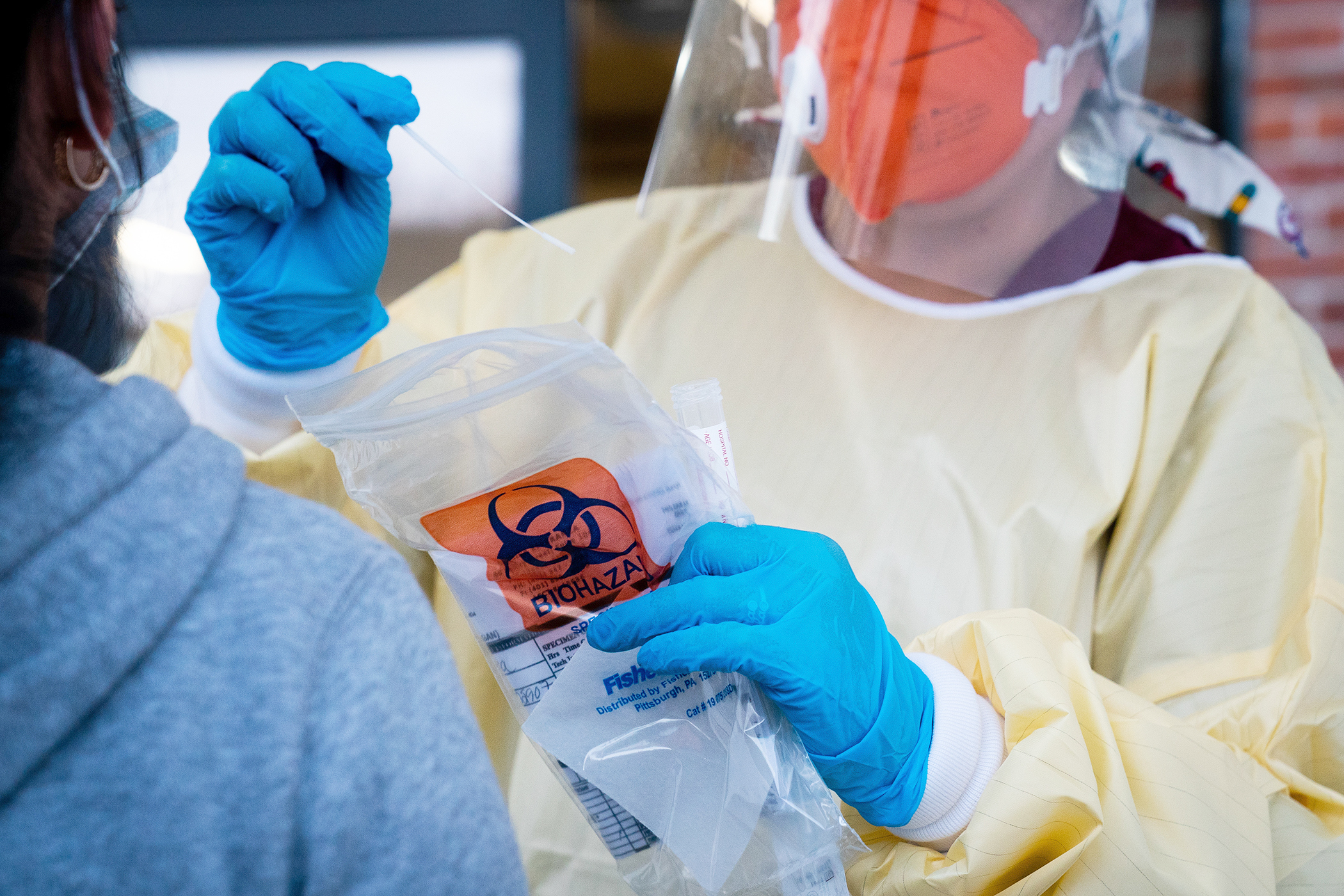 PHOTO: A health care worker administers a coronavirus test at a clinic in Providence, R.I., on Saturday, Nov. 7, 2020.