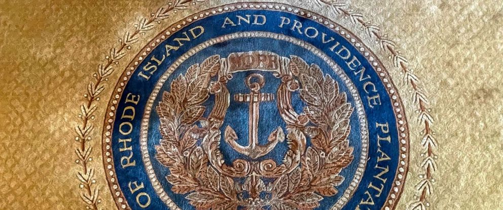 PHOTO: In this Nov. 4, 2021, file photo, the state seal with Rhode Islands full former name appears on a rug in the state room at the Rhode Island State House, in Providence, R.I.