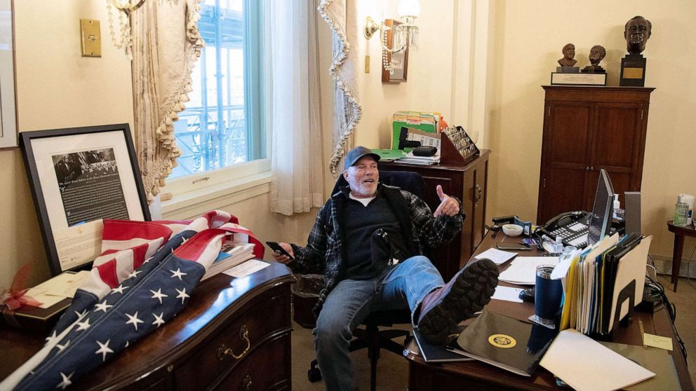 PHOTO: FILE - Richard Barnett, a supporter of US President Donald Trump sits inside the office of US Speaker of the House Nancy Pelosi as he protest inside the US Capitol in Washington, DC, Jan. 6, 2021.